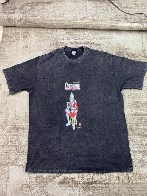 Vintage-wash black streetwear t-shirt featuring a graphic of a silver and red giant anime hero eating ramen noodles under 'Ultramie' text, custom DTF printed by Whavieprints.