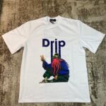 White streetwear graphic t-shirt featuring an octopus character wearing a beanie and flashing a peace sign under the text 'Drip', custom DTF printed by Whavieprints.