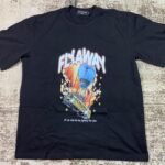 Black streetwear graphic t-shirt featuring a yellow school bus attached to a blue hot air balloon flying over flames and stars with 'Flyaway' text, custom DTF printed by Whavieprints.